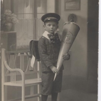 Klaus as a young boy with his schultute, a carboard cone filled with sweets given to students by their families.