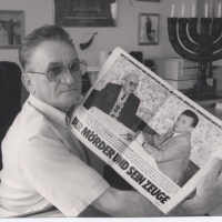 Thomas Blatt showing the article that features his meeting with Karl Frenzel, SS officer and Commandant at Sobibor. The meeting took place in 1983 in Hagen, Germany.