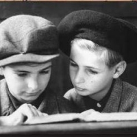 Two orphaned boys, Henry (left) and Fred (right) Taucher, at the first Rosh Hashanah service held in the city since 1938, Fraenkelufer Synagogue. (Berlin, September 7, 1945)